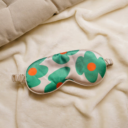 Green flower sleep mask on a soft blanket