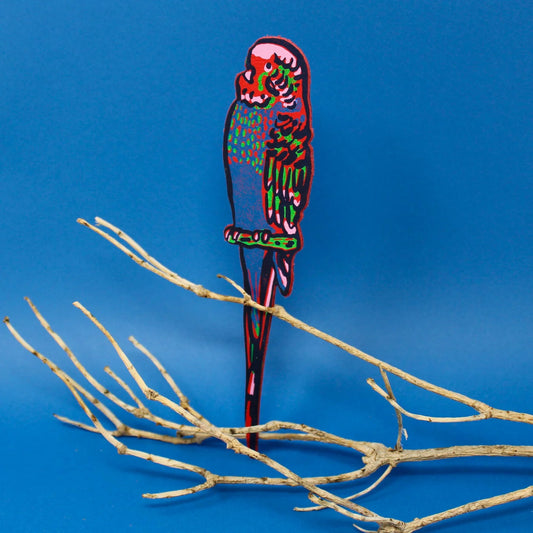 Red and green leather budgie bookmark perched on a branch