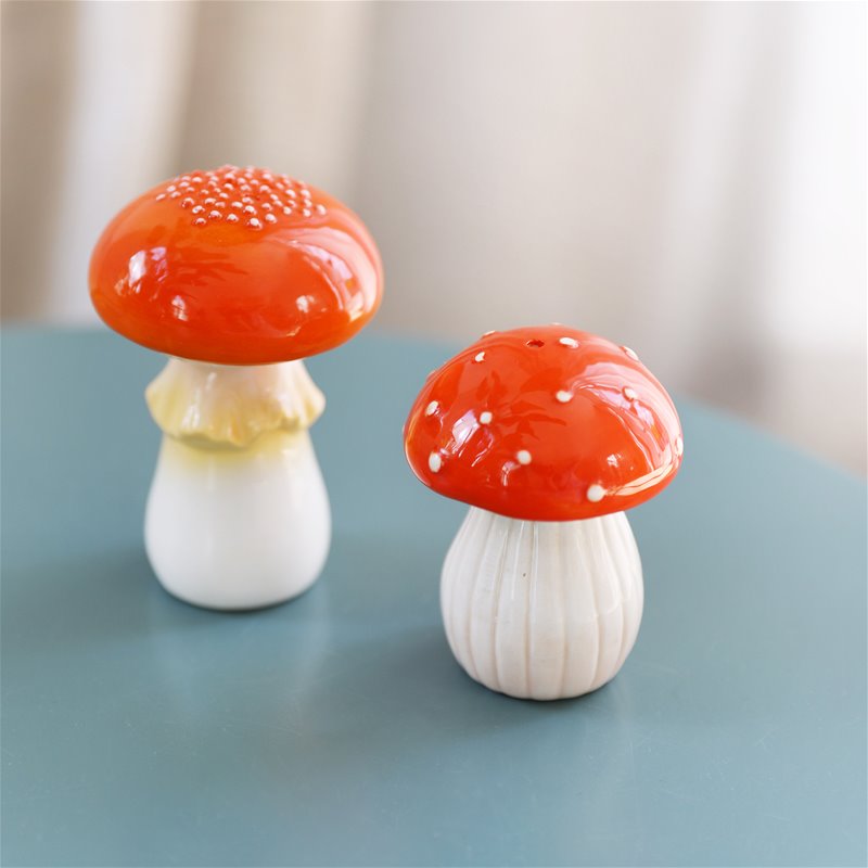 Toadstool salt and pepper shakers on a blue table
