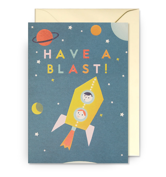 Lagom card: two children in a yellow rocket among planets, with 'Have a blast!'