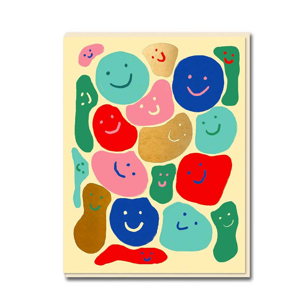 1973 card: colourful smiling blobs on cream