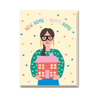 1973 card: a woman in glasses holding a pink house, with 'New home – happy home'
