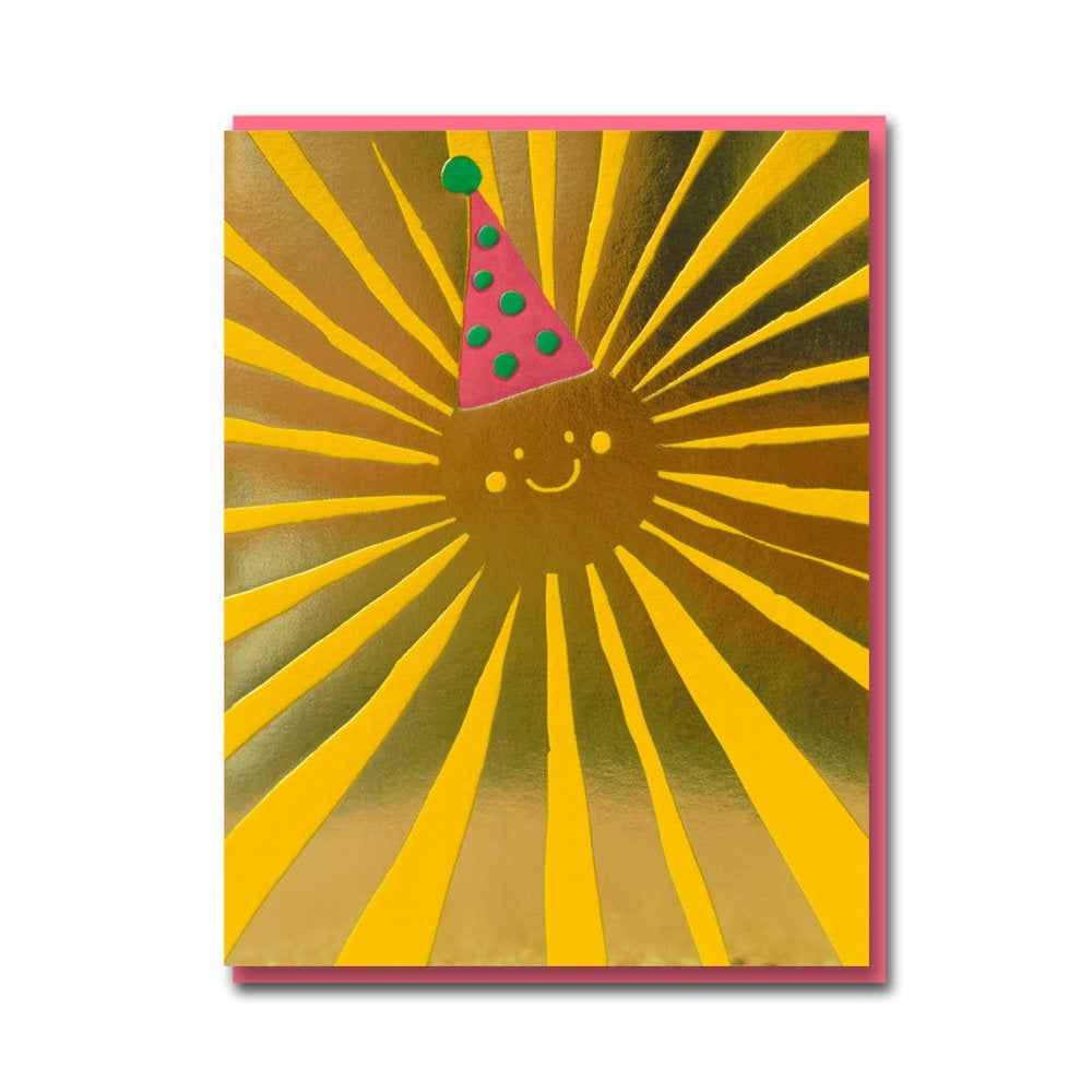 Gold foil card with a smiling sun wearing a pink party hat