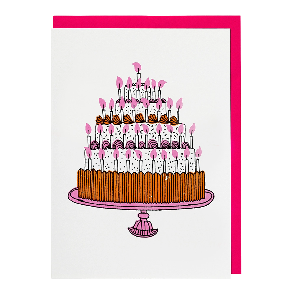 White card with a tall tiered chocolate birthday cake covered in pink candles, with a pink envelope