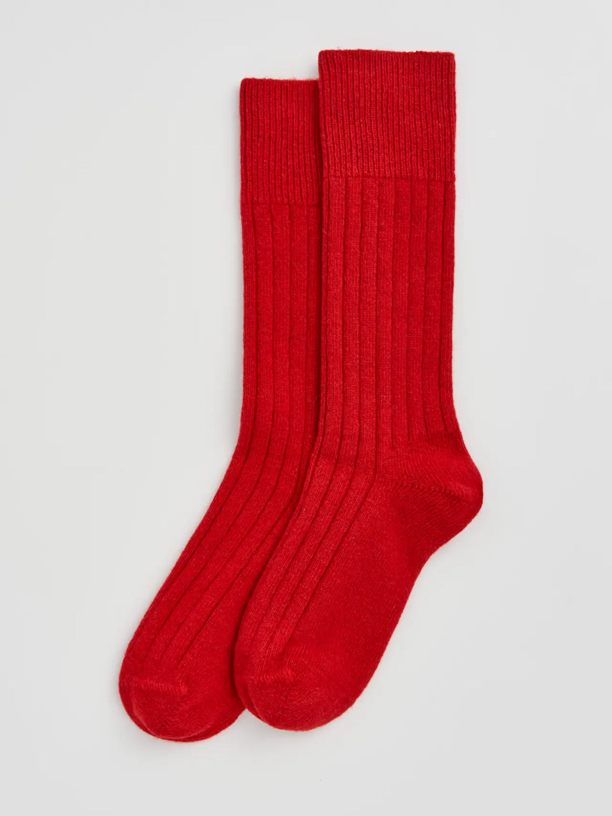 Pair of postbox red ribbed bed socks laid flat