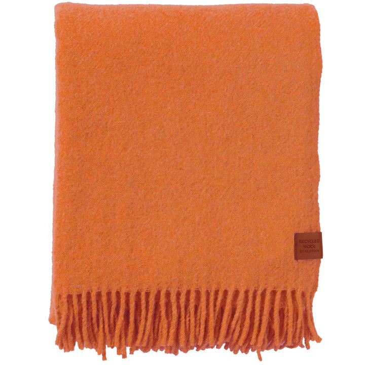 Klippan recycled wool and lambswool blanket in orange with fringed ends, folded