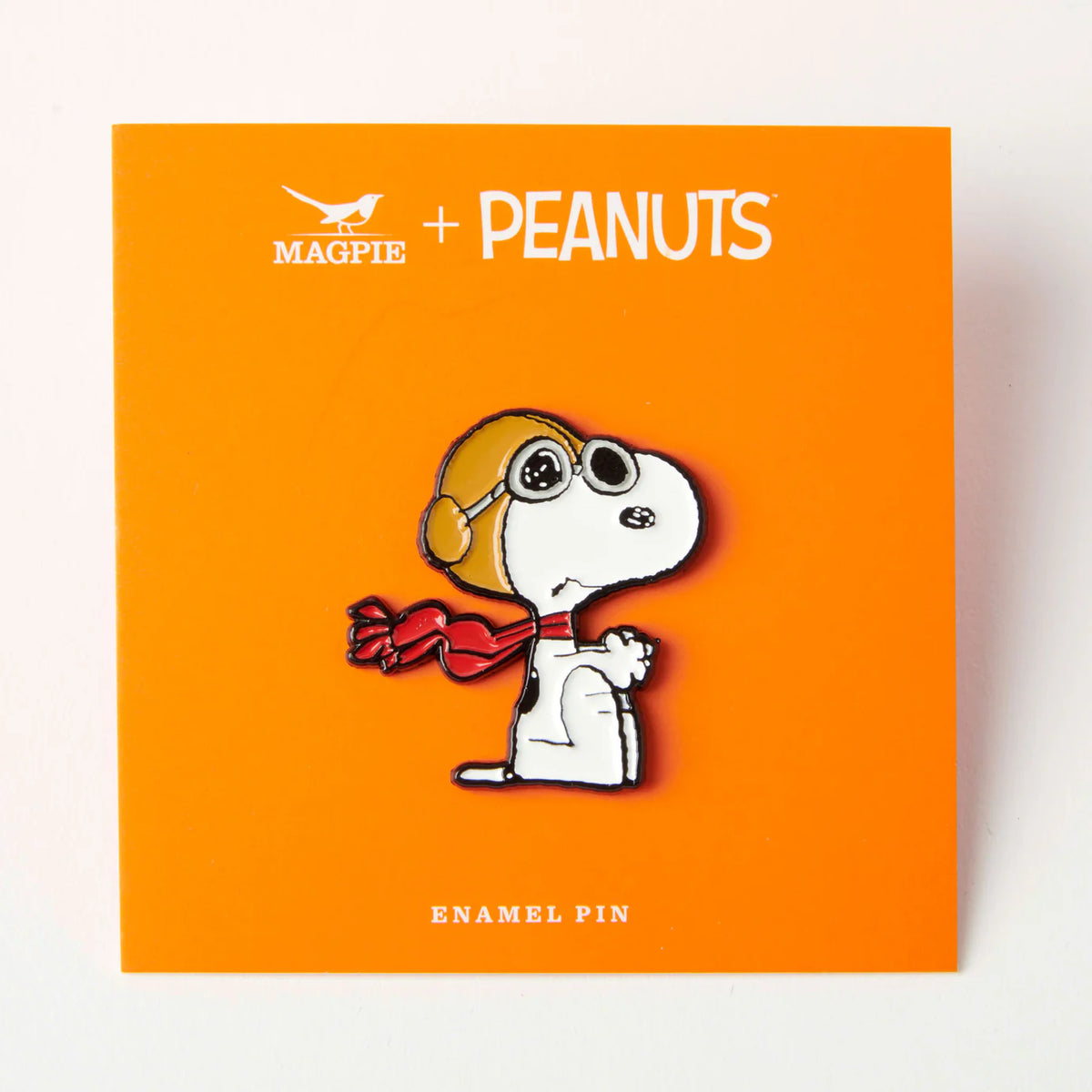 Flying Ace pin on its orange Magpie x Peanuts backing card