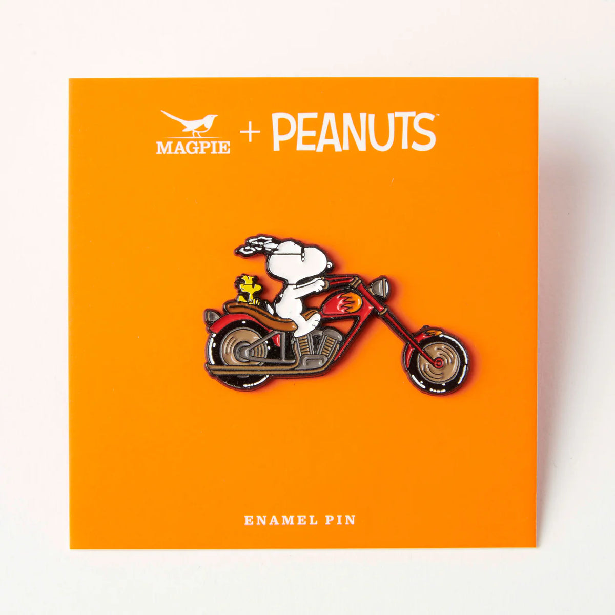 Biker Snoopy pin on its orange backing card