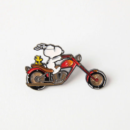 Enamel pin of Snoopy riding a red chopper motorbike with Woodstock