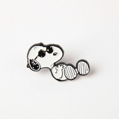 Enamel pin of Snoopy lounging in sunglasses