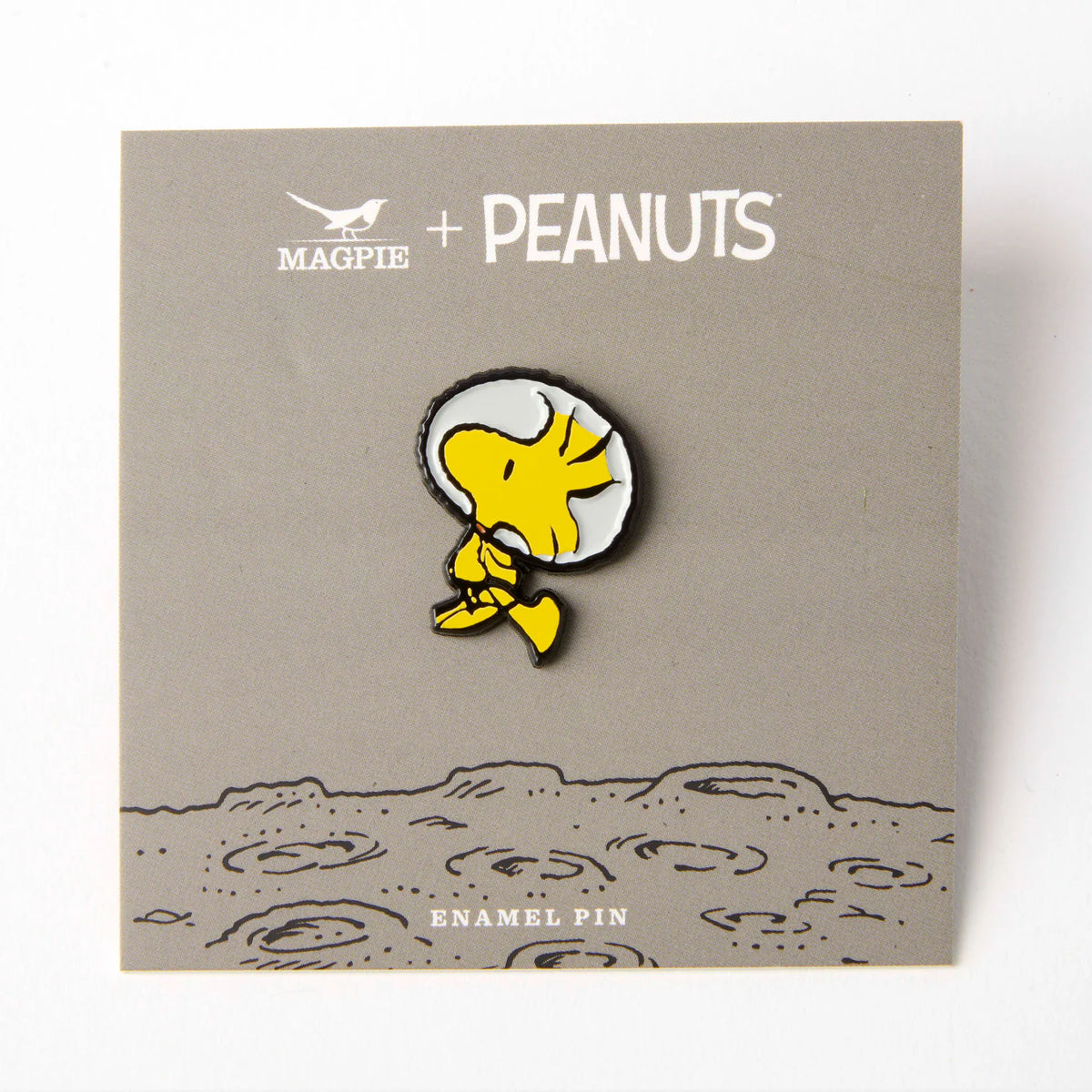 Woodstock space pin on its grey moon backing card