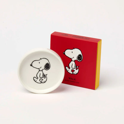 Small white Snoopy walking trinket dish beside its red box