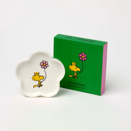 Flower-shaped Peanuts trinket dish with Woodstock holding a pink flower, beside its green box