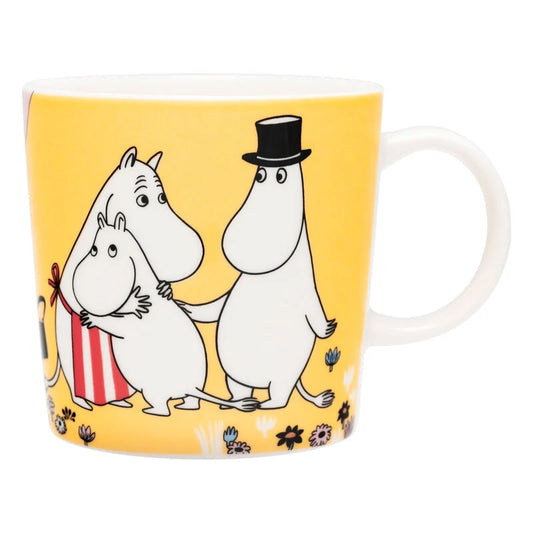 Moomin 80 Family Time mug: Moominpappa, Moominmamma and Moomintroll together on yellow