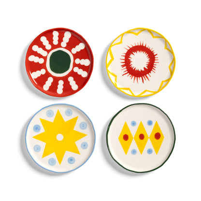 &K Festivo small plates in four designs: red with white dots, yellow with a red burst, a yellow star and yellow diamonds
