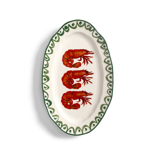 &K shrimp platter: an oval white plate with three red prawns and a green rim