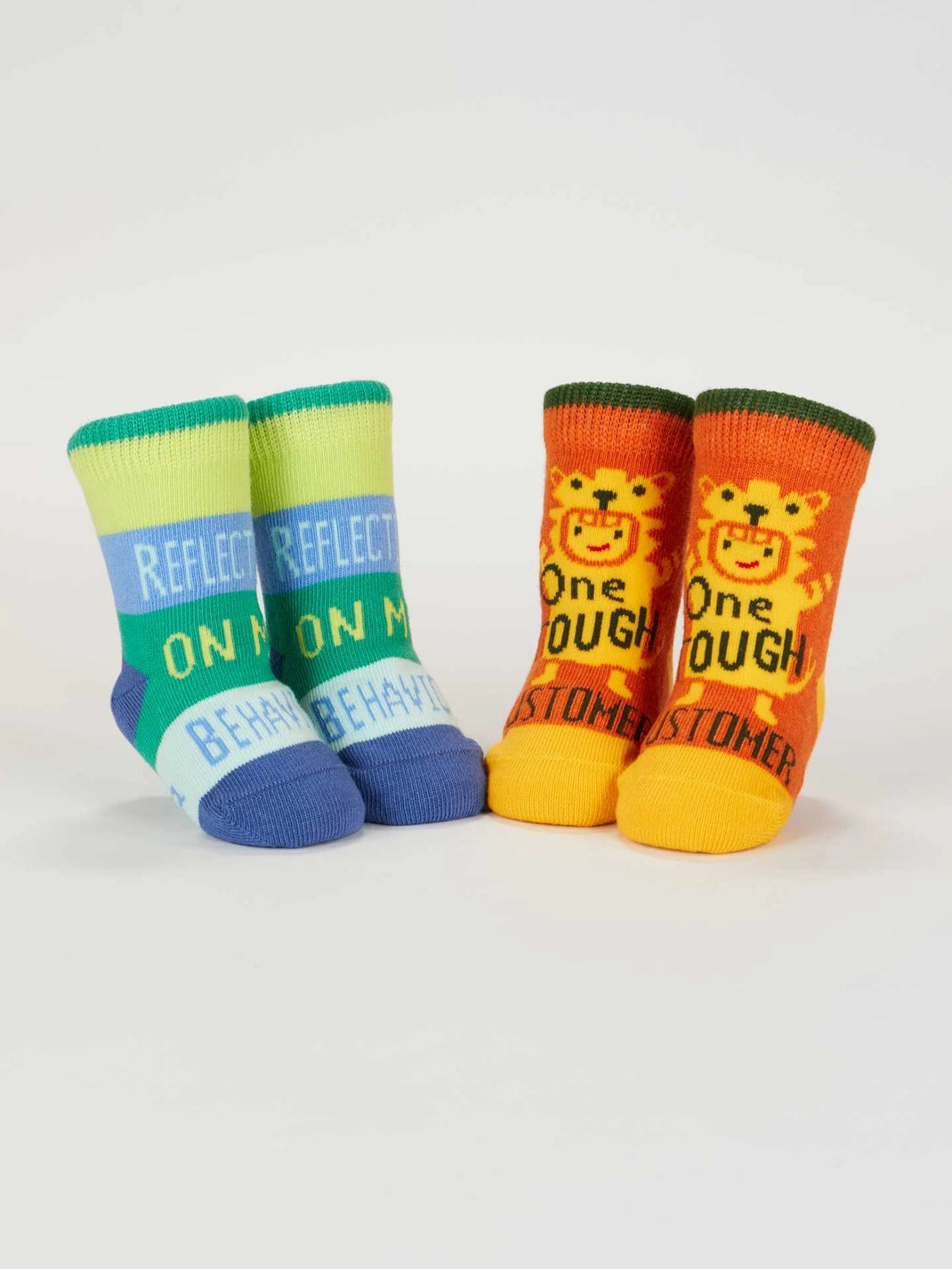 Both pairs of baby socks standing upright