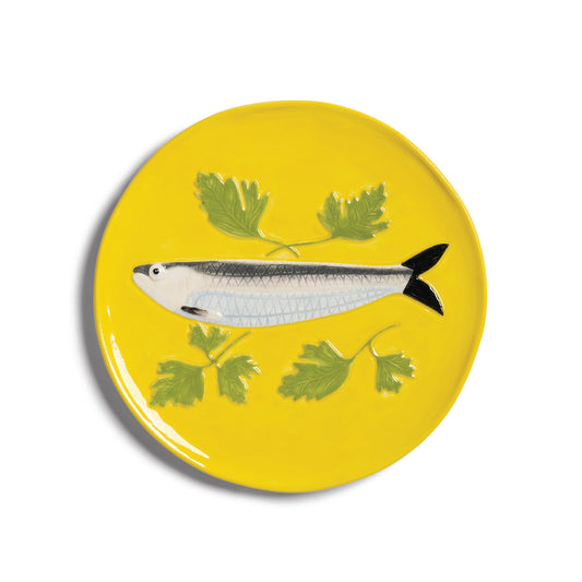 &K yellow sardine plate: a silver sardine and parsley on yellow