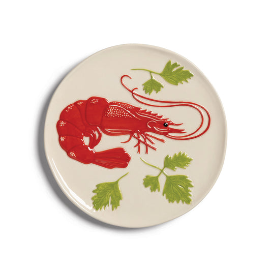 Cream plate painted with a red shrimp and parsley leaves