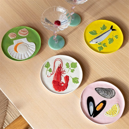 Seafood plates on a wooden table with a cocktail glass