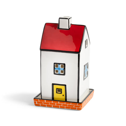 &K Haines townhouse tealight holder: a white house with a red roof and yellow door on a brick base