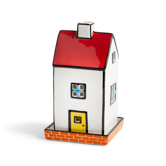 &K Haines townhouse tealight holder: a white house with a red roof and yellow door on a brick base