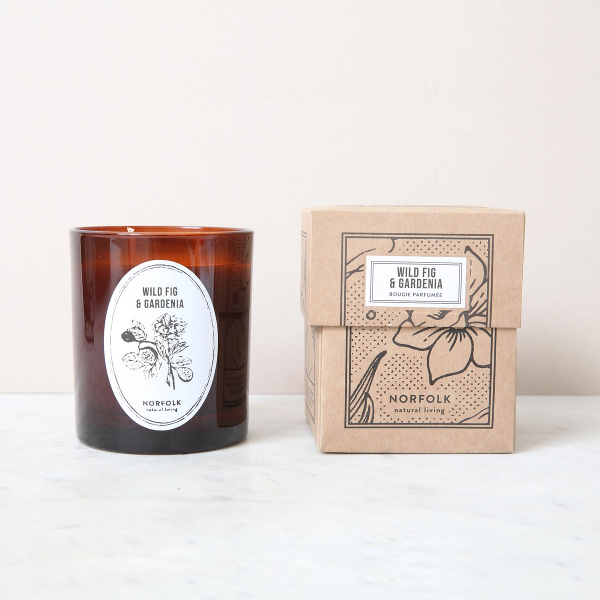 Wild Fig & Gardenia candle next to its kraft paper gift box