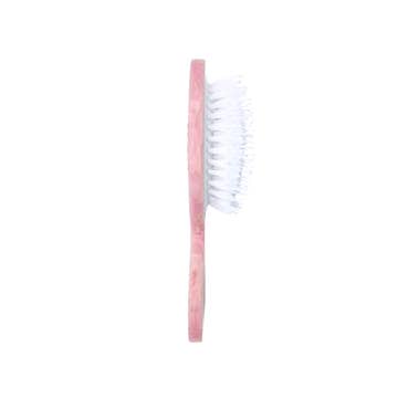 Pink hairbrush from the side