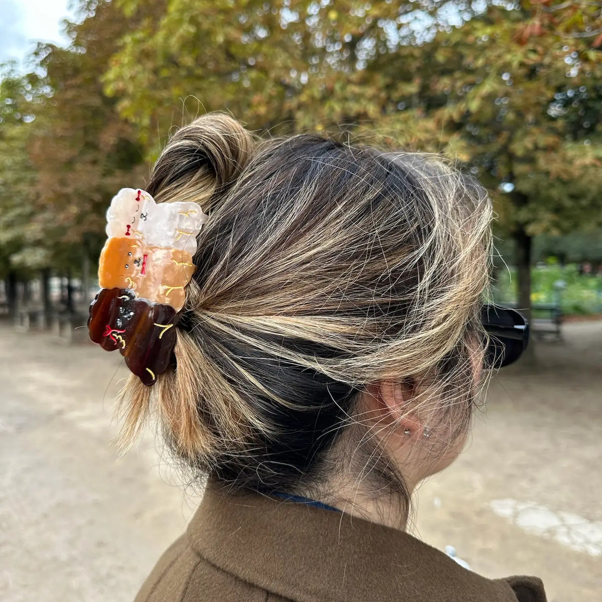 Puppies claw clip holding up hair in a park