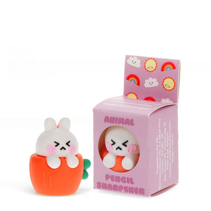 White bunny pencil sharpener sitting in an orange carrot, beside its box