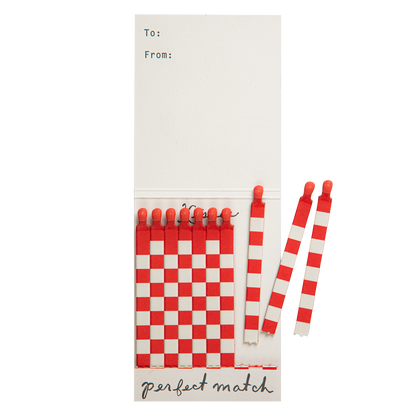 Lipstick match book open with a few red and white matches pulled out