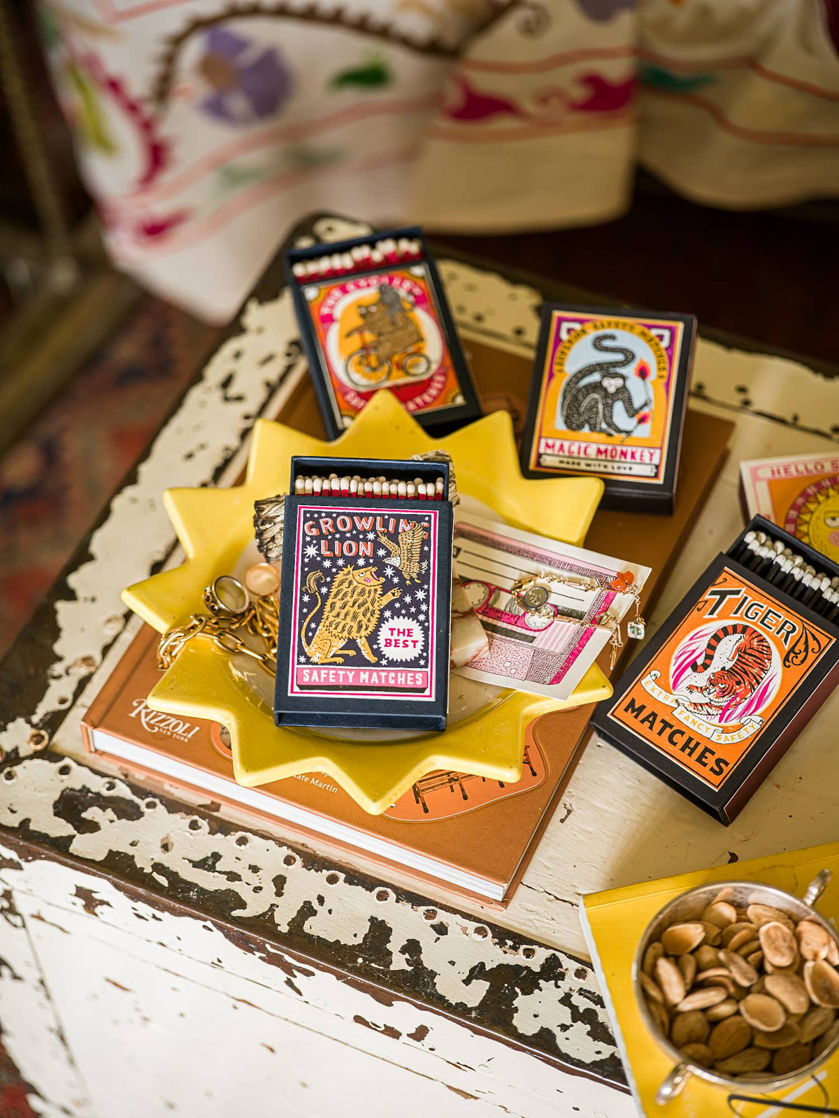 Growling Lion box among Archivist matchboxes on a yellow dish