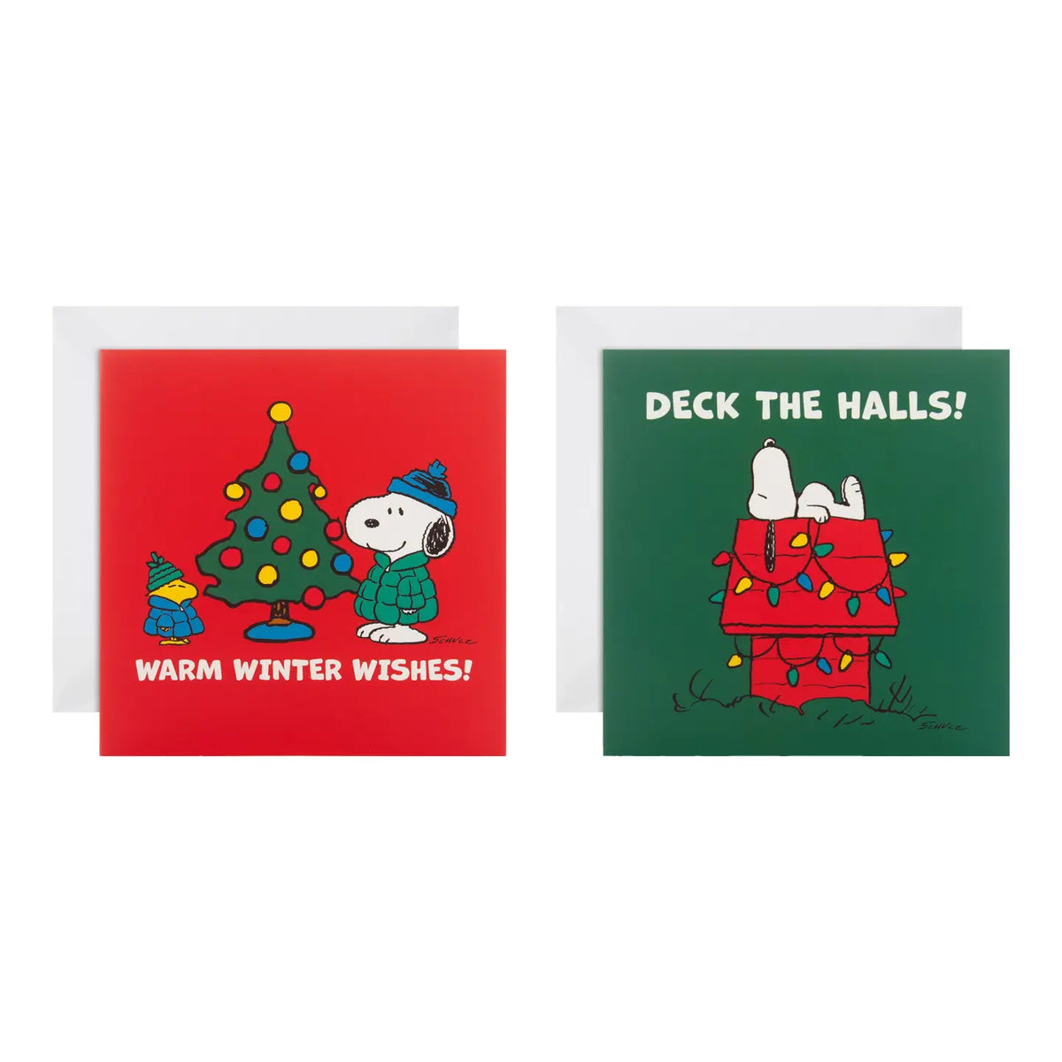 Peanuts Christmas cards in two designs: Snoopy decorating a tree ('Warm winter wishes') and Snoopy on his lit-up doghouse ('Deck the halls!')