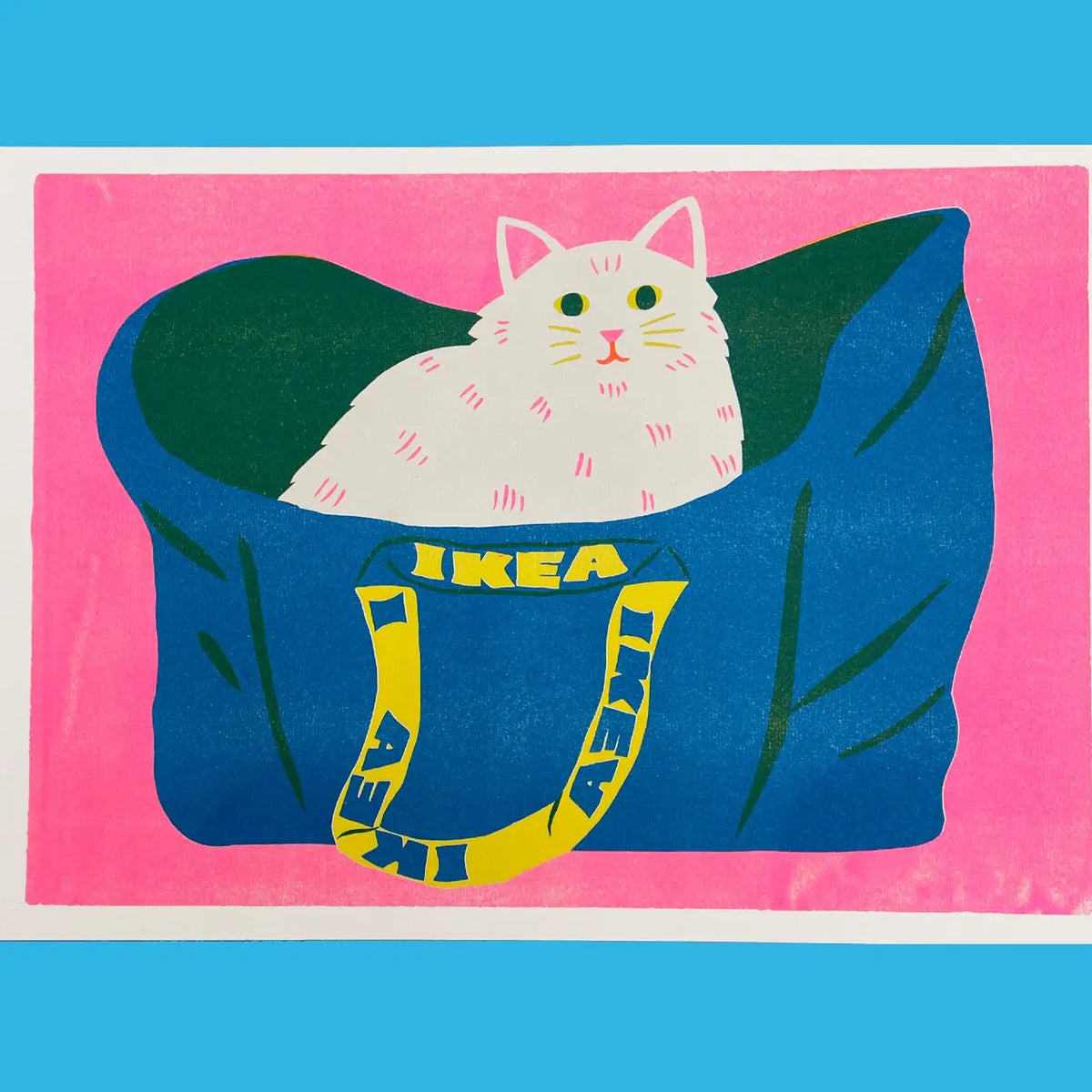 Naomi Wilkinson A3 riso print: a fluffy white cat sitting in a blue IKEA bag on pink