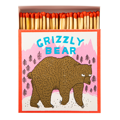 Square matchbox with a grizzly bear, open to show red-tipped matches