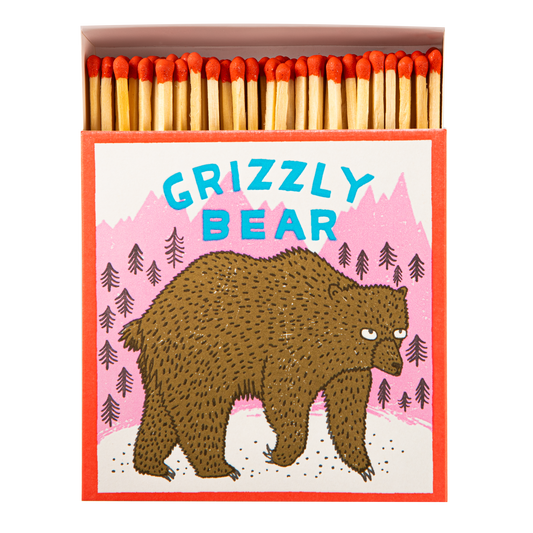 Square matchbox with a grizzly bear, open to show red-tipped matches