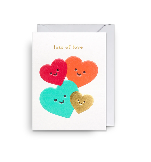 Lagom mini card: four smiling hearts in red, orange, teal and gold, with 'Lots of love'