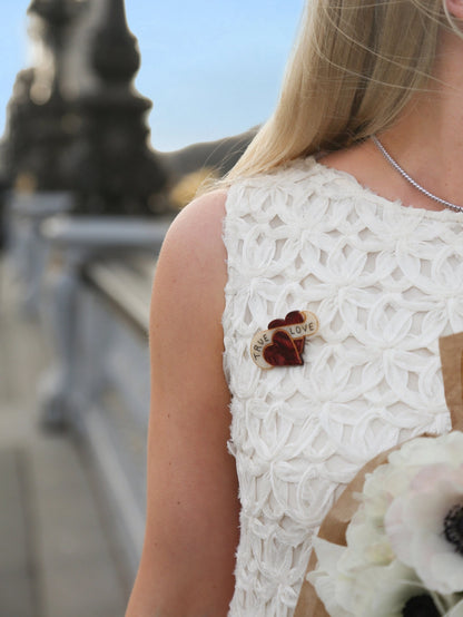 True Love brooch on a white lace dress