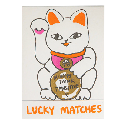 Archivist Lucky Matches book: a white lucky cat holding a coin reading 'Always think pawsitive'