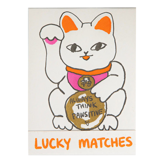 Archivist Lucky Matches book: a white lucky cat holding a coin reading 'Always think pawsitive'