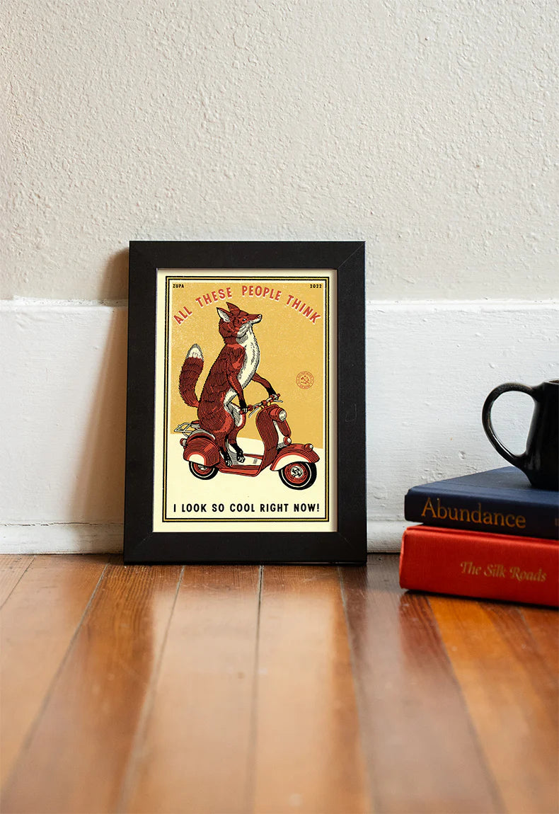 Fox print in a black frame on a wooden floor