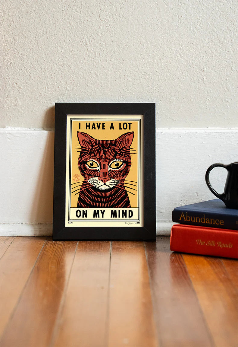 I Have a Lot on My Mind print in a black frame on a wooden floor