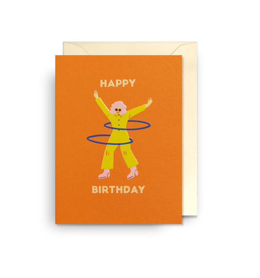 Lagom mini card: a woman in yellow spinning a hula hoop on orange, with 'Happy birthday'