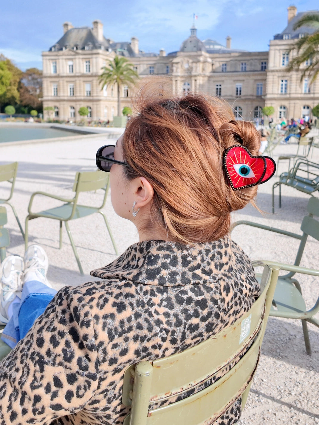 Lucky eye heart clip in hair, in a Paris park