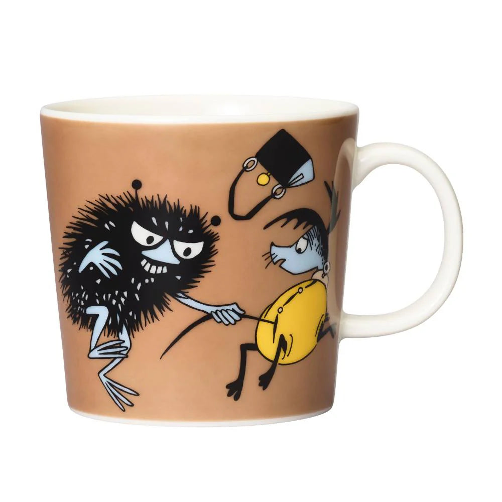 Stinky in Action mug: scruffy black Stinky grabbing a police officer's helmet, on brown