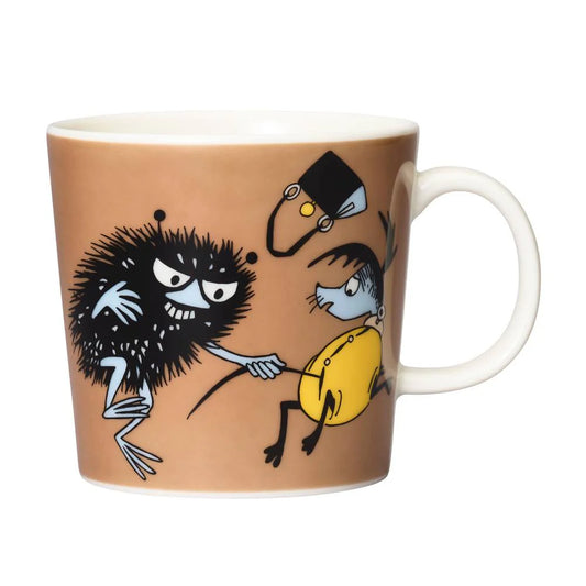 Stinky in Action mug: scruffy black Stinky grabbing a police officer's helmet, on brown