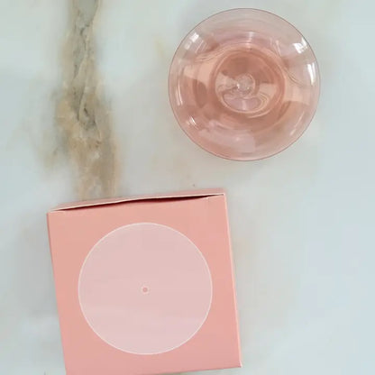 Coral translucent glass incense holder from above, with its pink box