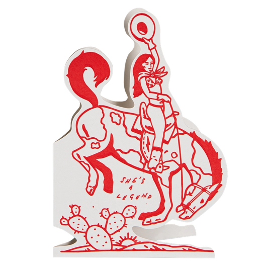 Archivist cut-out card in red and white: a cowgirl on a bucking horse, with 'She's a legend'