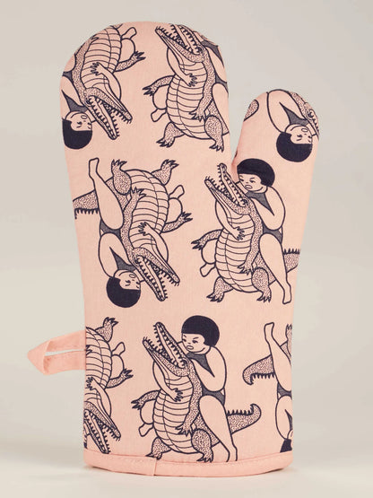 Back of the oven mitt with a pattern of figures and crocodiles