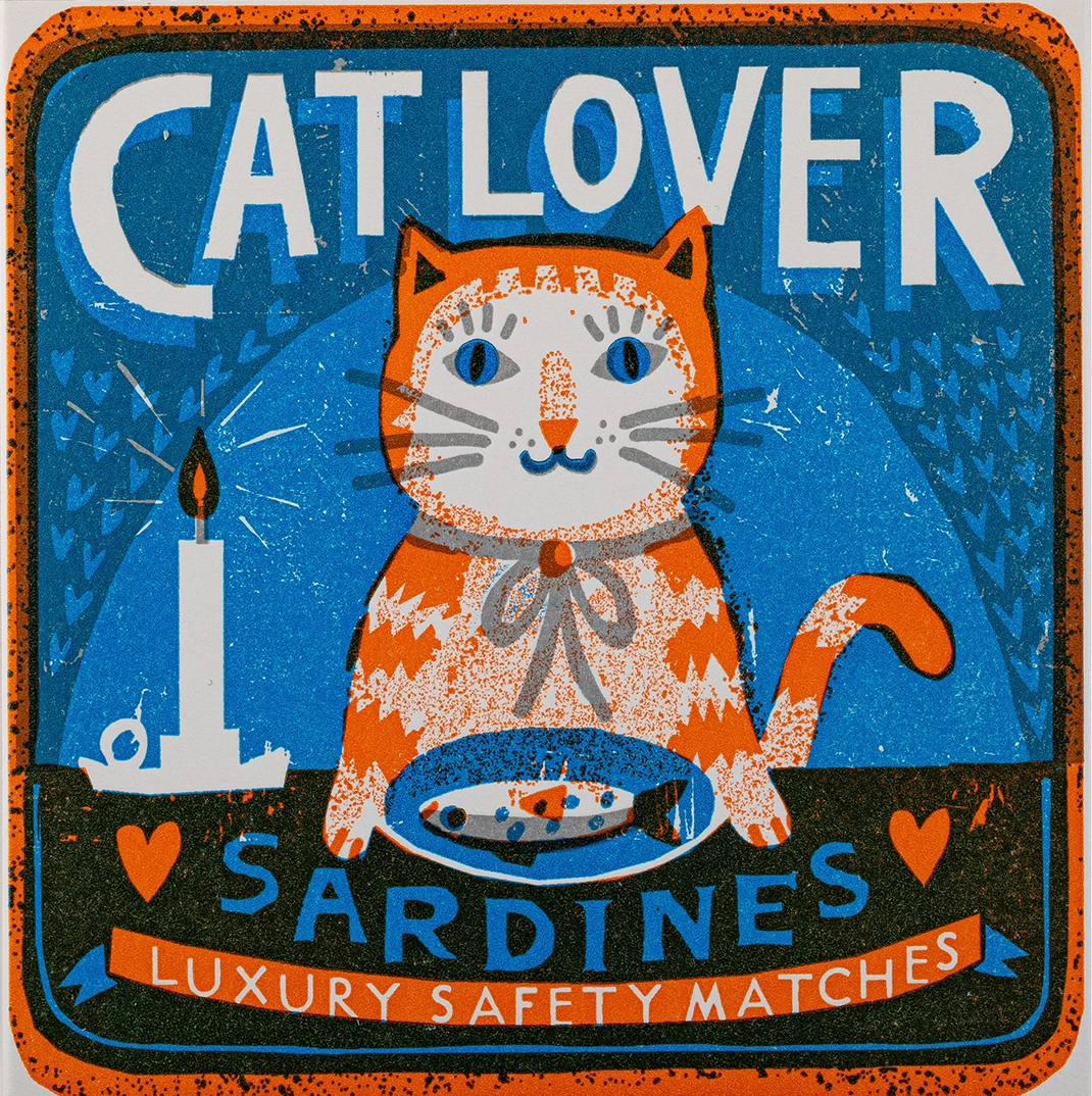 Archivist Cat Lover matchbox: a ginger cat with a plate of sardines, with 'Cat lover sardines – luxury safety matches'